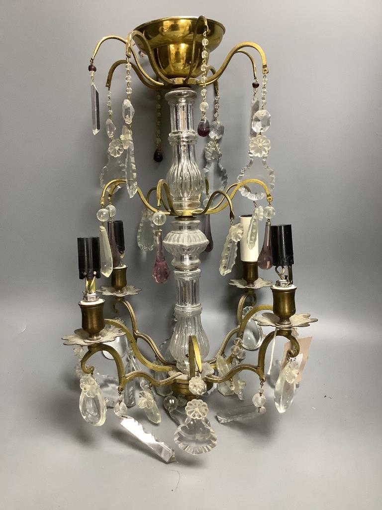 A French boudoir four-light chandelier with clear and amethyst glass pendant drops and a similar pair of French two-light bedside lamps H 57.5cm Dia 36cm